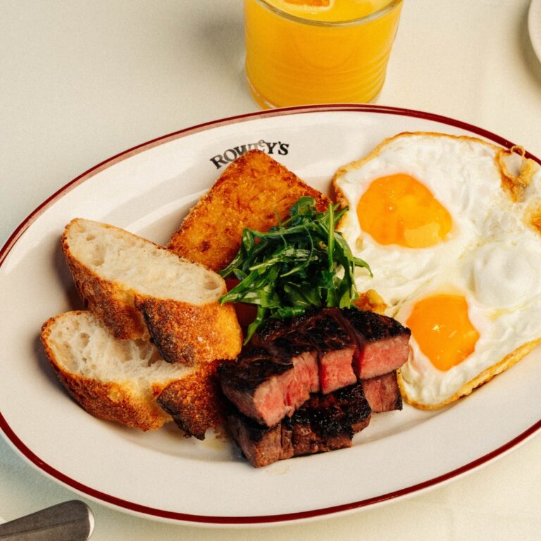 Steak and eggs breakfast with hash browns and orange juice at Rowley's DIFC